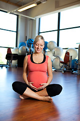 Image showing Pregnant woman smiling and relaxing.