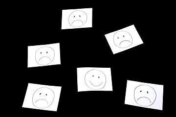 Image showing a smile surrounded by sad faces