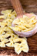 Image showing uncooked pasta in wooden spoon