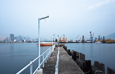 Image showing Deserted jetty at a foggy sea near a dutch city. 