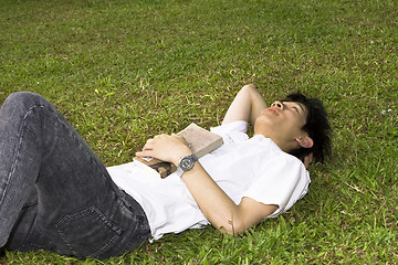 Image showing asia man relax on the grass