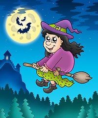 Image showing Cute witch on broom near castle