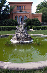 Image showing Small fountain with sculptures of boys in garden