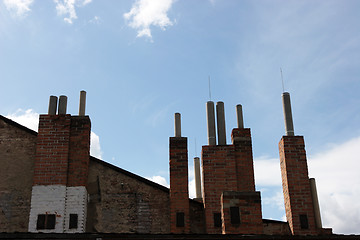 Image showing Many of brick chimneys on the top of the house