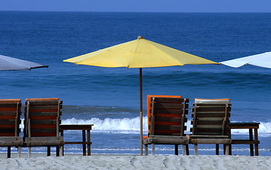 Image showing colorful beach umbrellas with seats