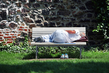 Image showing Man sleeping on bench