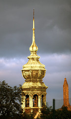 Image showing Golden tower of the church in the cloudy sky