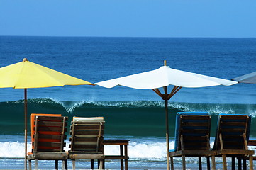 Image showing colorful beach umbrellas with seats