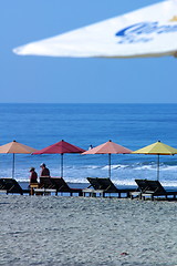 Image showing colorful beach umbrellas with seats