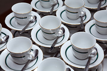 Image showing White porcelain tea cups with gold decoration