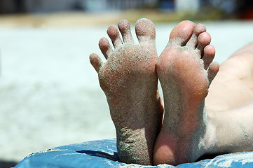 Image showing Feet of woman lying on the beach