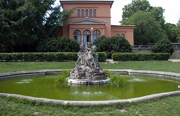 Image showing Small fountain with sculptures of boys in garden