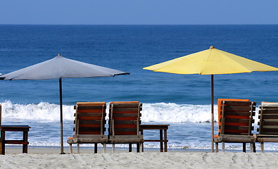 Image showing colorful beach umbrellas with seats