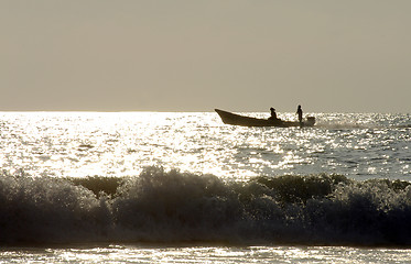 Image showing Silhouette of two men on boat during sunset