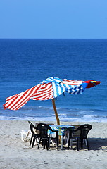 Image showing colorful beach umbrellas with seats