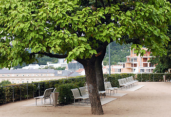 Image showing Park on the riverside with white benches