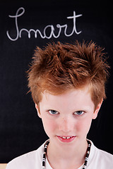 Image showing Cute and smart kid, in front of blackboard