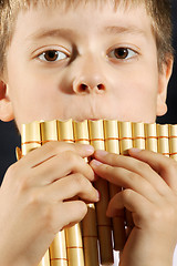 Image showing Boy playing panflute