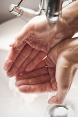 Image showing Washing hands under tap