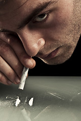 Image showing Young man sniffing cocaine.