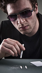 Image showing Young man sniffing cocaine.