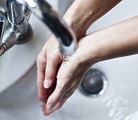 Image showing Washing hands under tap