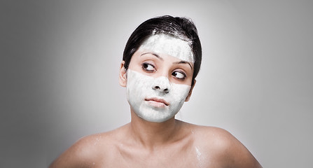 Image showing Cosmetician make mask to girl. Facial massage.