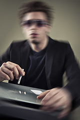 Image showing Young man sniffing cocaine.
