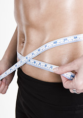 Image showing measuring tape around slim beautiful waist