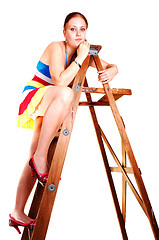 Image showing Pretty girl on the stepladder.