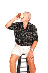 Image showing Senior on a bar chair.