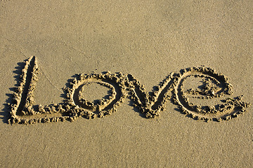 Image showing love message written in sand 