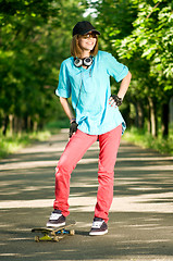 Image showing Teenage girl with skateboard