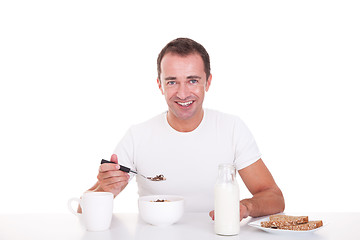 Image showing handsome man taking breakfast