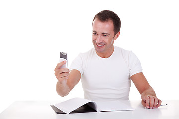 Image showing man at the desk and on the phone