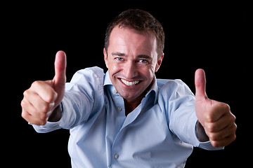 Image showing Young businessman with thumb raised as a sign of success