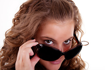 Image showing portrait of a young woman looking over her sunglasses,