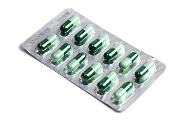 Image showing Package of green capsules  isolated on white