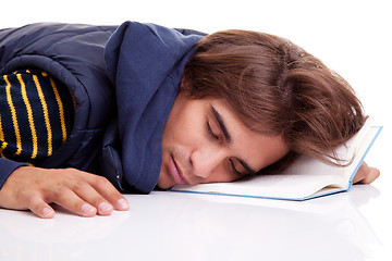 Image showing young man lying asleep on a book