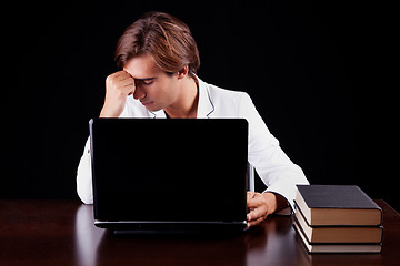 Image showing Tired young businessman on the computer 