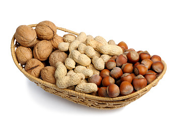 Image showing Set of nuts in a wicker basket, isolation