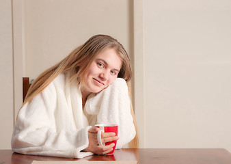 Image showing young woman with coffee in morning