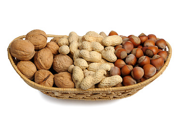 Image showing Set of nuts in a wicker basket, isolated