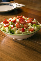 Image showing Bowl of Salad and an Empty Plate on the Background