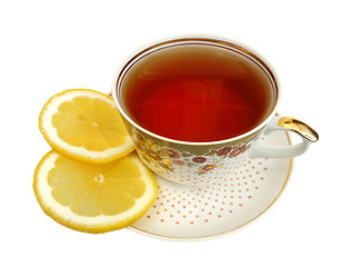 Image showing A cup of tea and slices of lemon