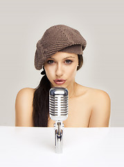 Image showing Sexy woman singing in retro mic