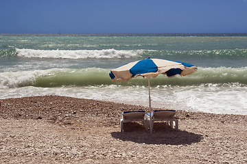 Image showing Beach chairs and umbrella