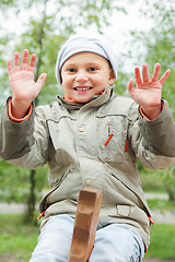 Image showing Smiling boy on seesaw