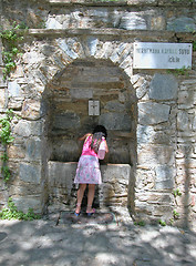 Image showing A girl drinks at the spring of Meryemana (Virgin Mary's House)