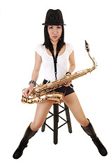 Image showing A saxophonist sitting.